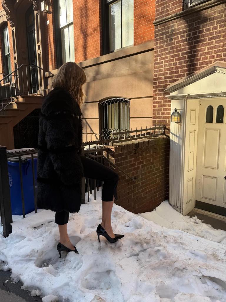 Olivia Jade treks through the snow in heels. 