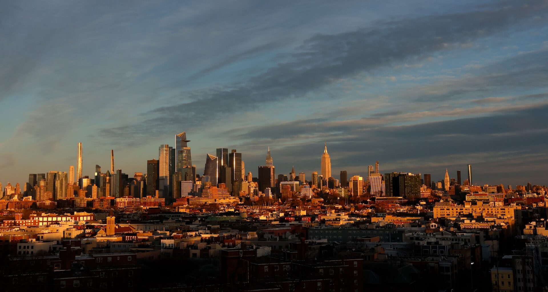 JERSEY CITY, NJ - DECEMBER 21: The sun sets on the skyline of midtown Manhattan and the Empire State Building on the winter solstice in New York City on December 21, 2025, as seen from Jersey City, New Jersey.