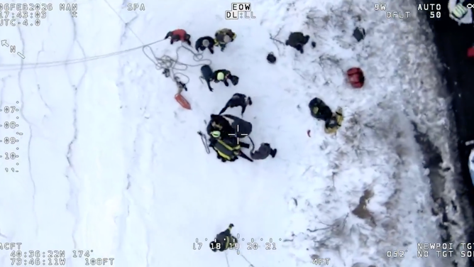 Crews attempt to dry and warm the three people pulled from the ice.