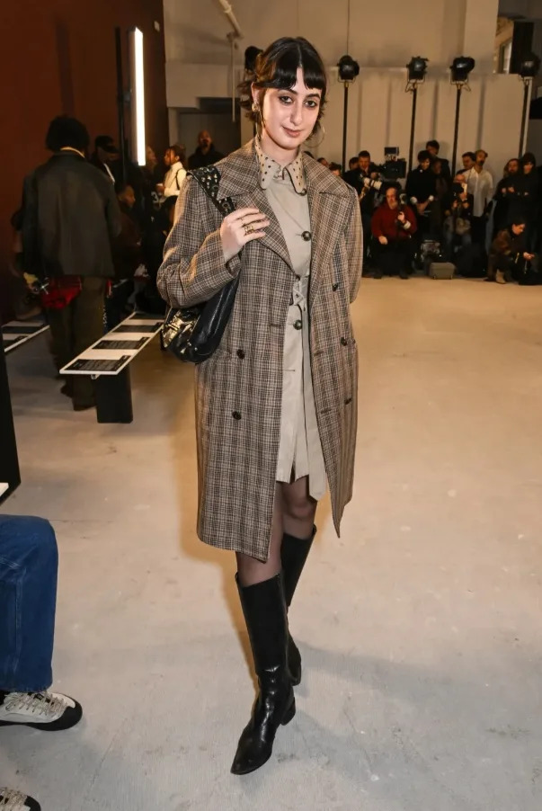 Rama Duwaji steps out at the Diotima Fall 2026 presentation in layered trench coats and sleek black leather boots.