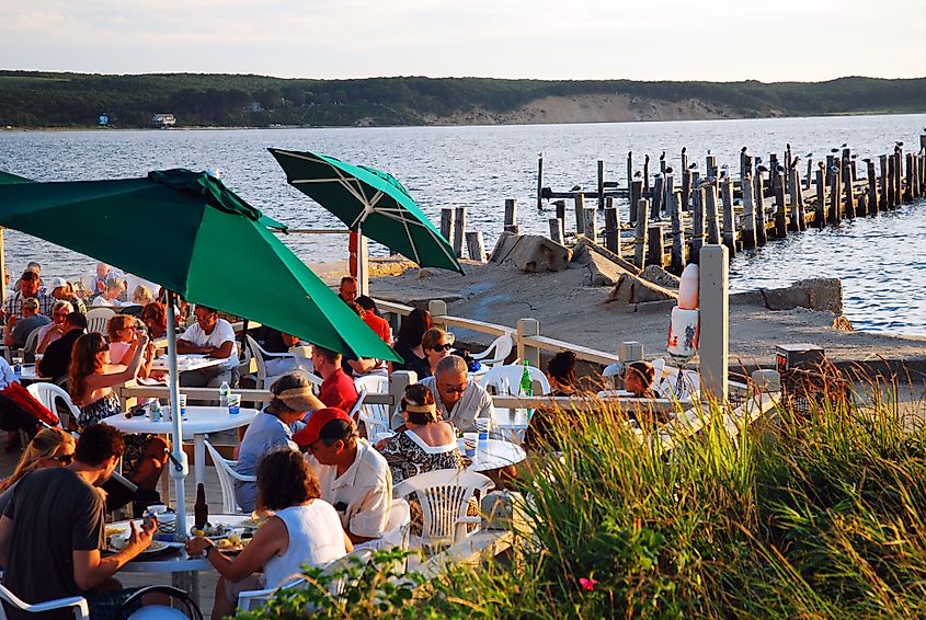 People enjoy a summer afternoon eating alfresco on the water at a resort in Montauk, New York