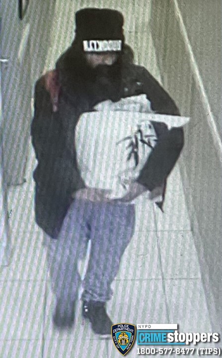 A second surveillance image of the suspect shows him without the crutches.