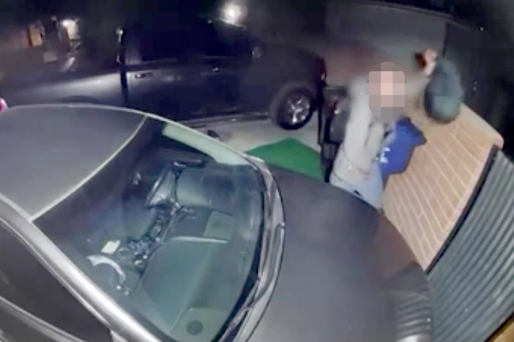 Ring camera footage showing a man with a backpack near two cars.