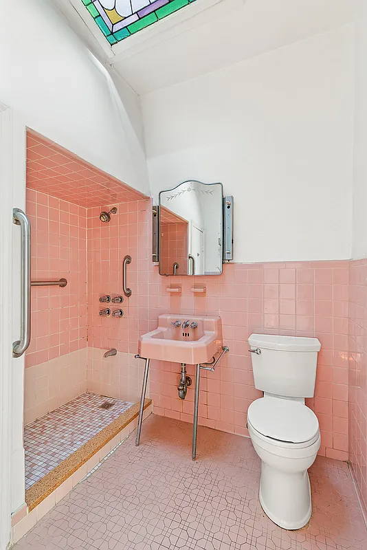 bathroom with stained glass skylight, pink tile and sink with a shower