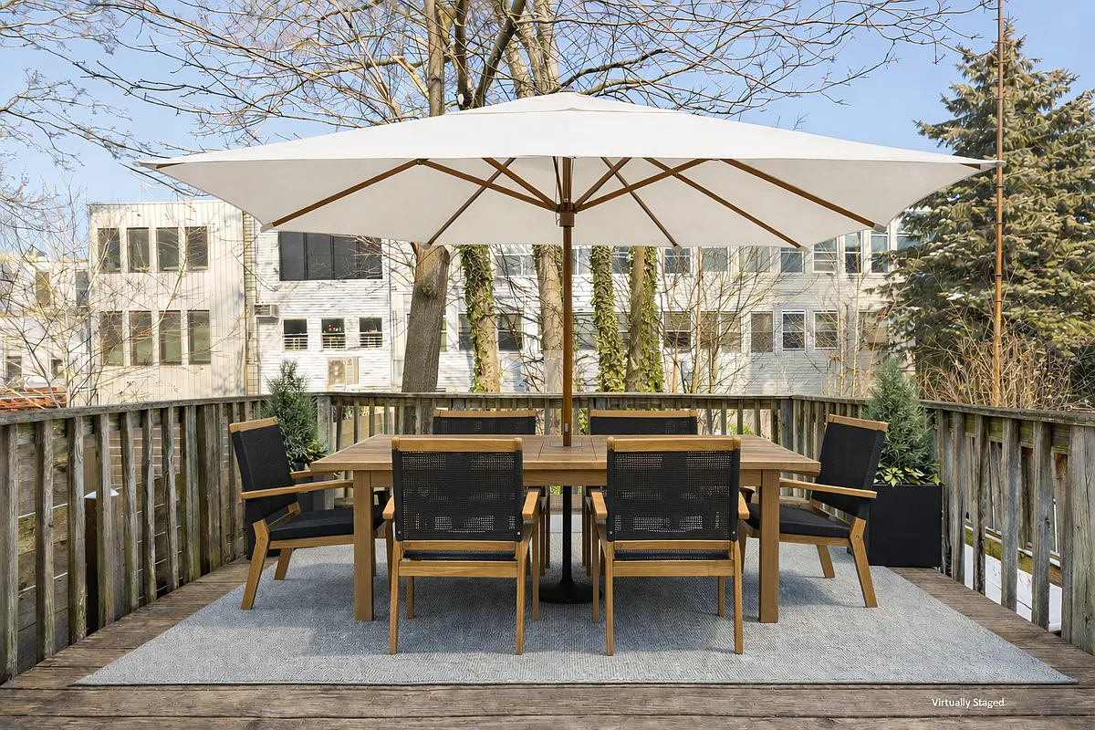 virtually staged deck with large table and chairs