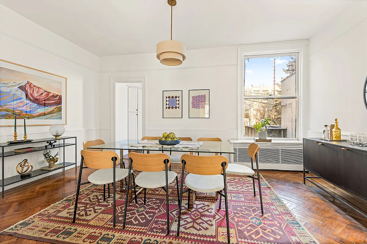 dining room with wood floor, picture rail, white walls