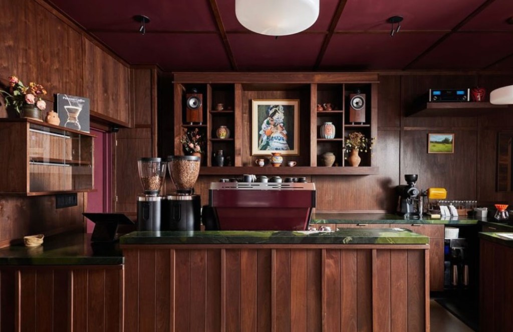 A coffee shop with a wood-paneled interior and a dark red ceiling.
