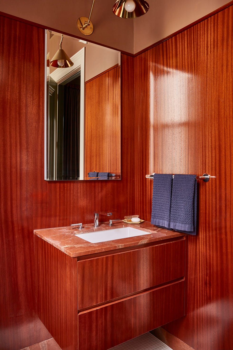 modern bathroom with wooden walls and coordinating wood vanity