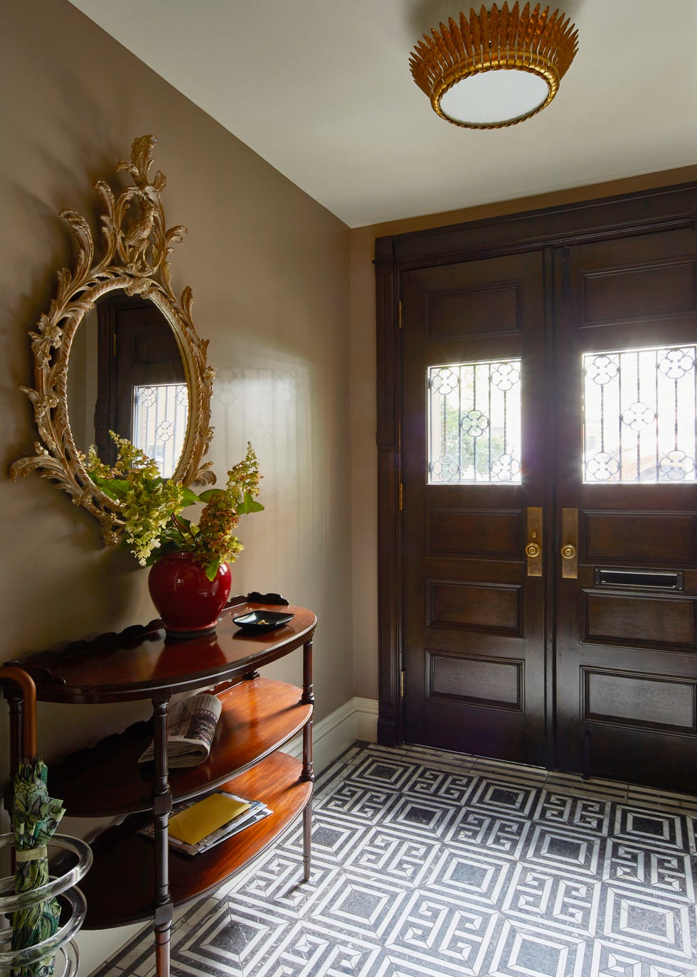 foyer with black front door and black and white patterned flooring