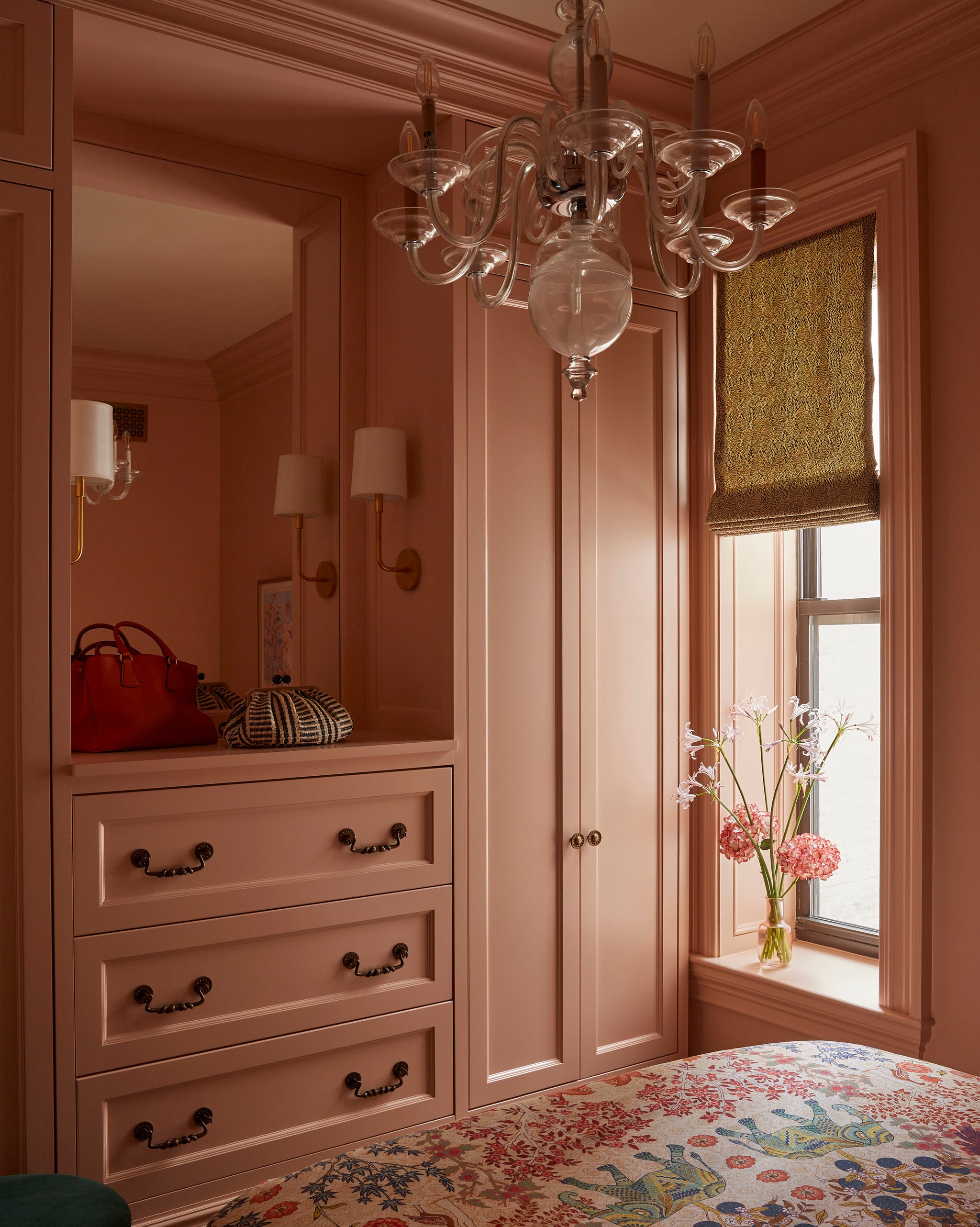 bedroom with pink painted built in drawers and cabinets