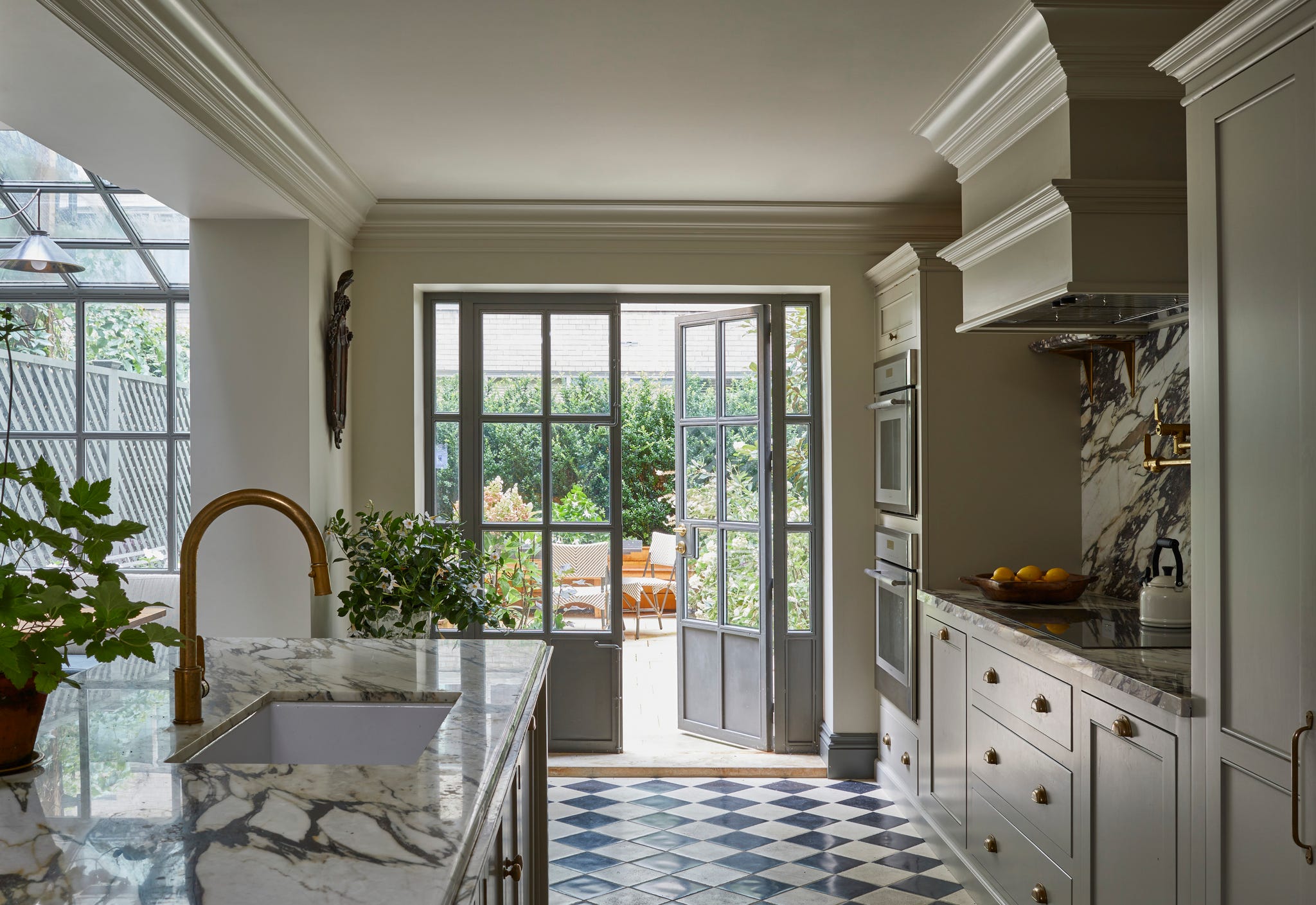 kitchen with black and white flooring and doors leading to an outdoor garden