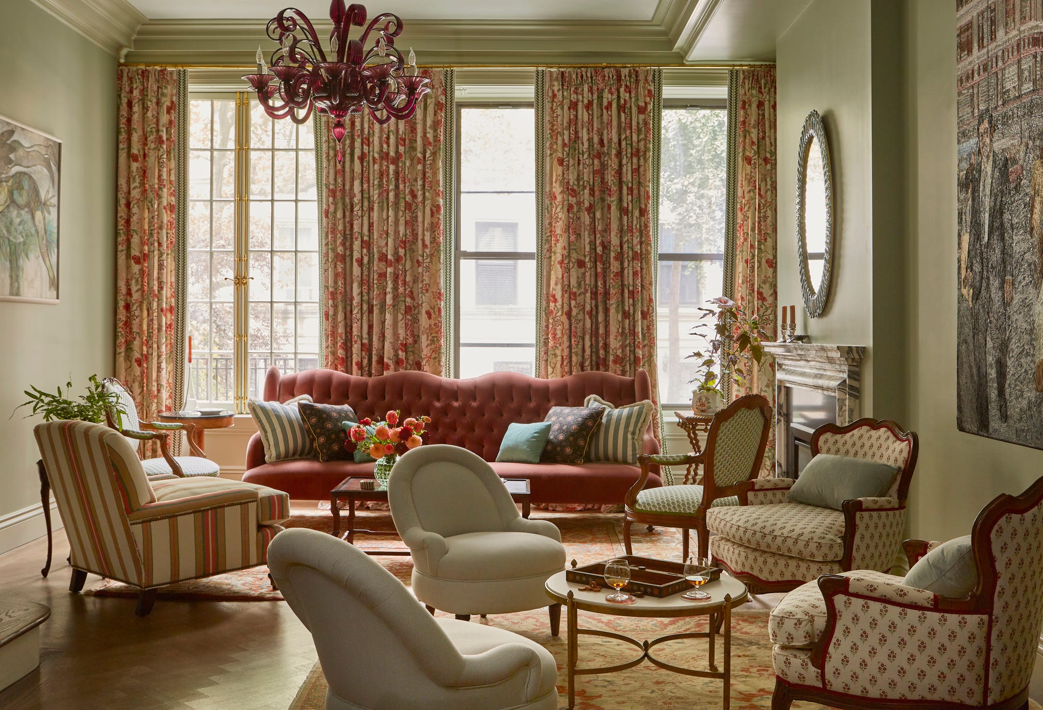 parlor with patterned curtains, chairs in different fabrics and a couch