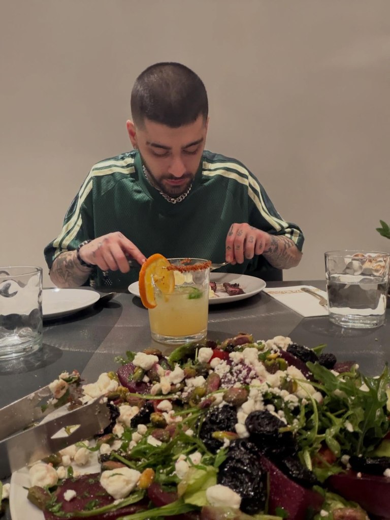 Zayn chows down in his Airbnb. 
