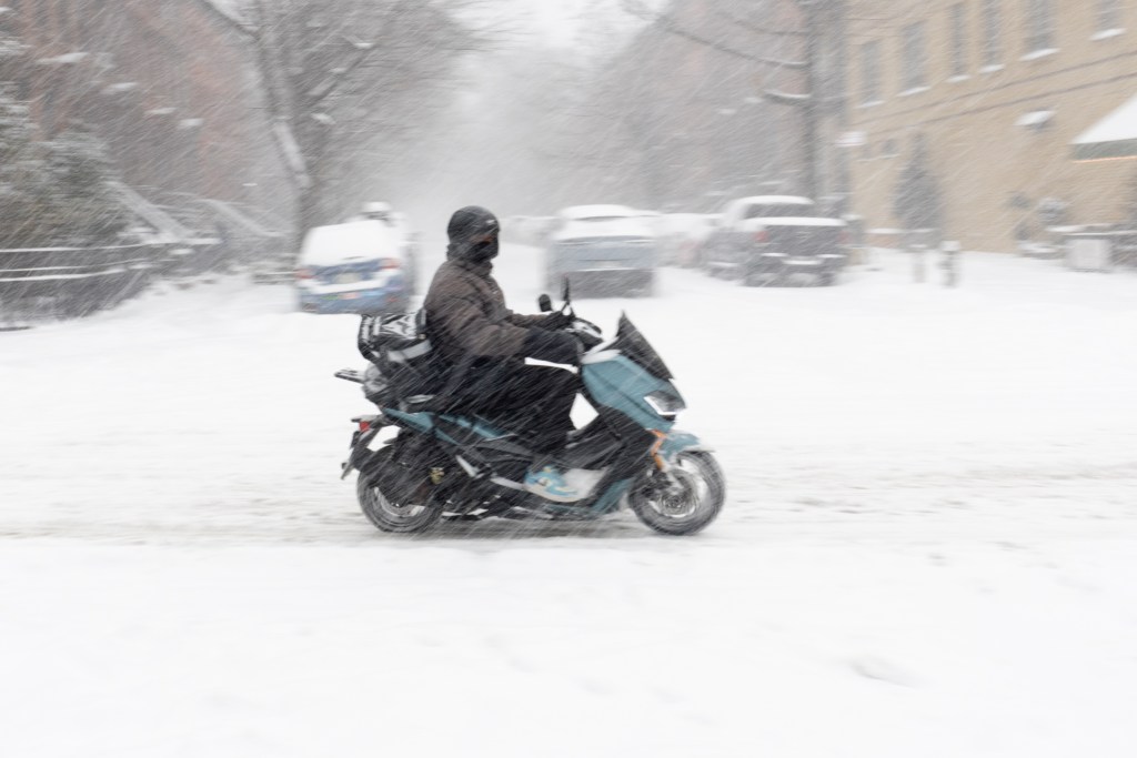 A delivery worker braves the snow in Brooklyn,