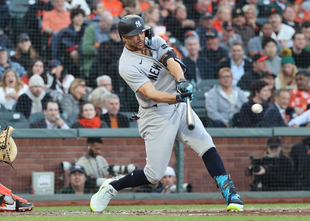 Giancarlo Stanton (27) hits a RBI single during the fifth inning.