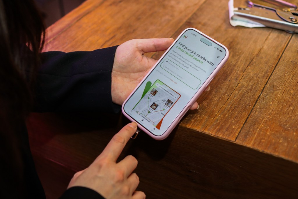 Holly Diamond displays her AI human resources app to help people find restaurant jobs in NYC,