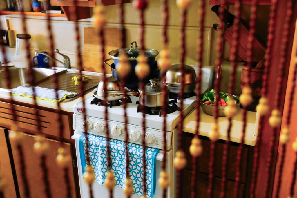 NYCHA resident Yu Zhen Story had pots and pans sitting on her stove.