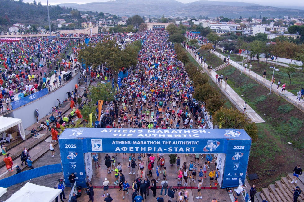 Athens Marathon start line crowded with runners and spectators.