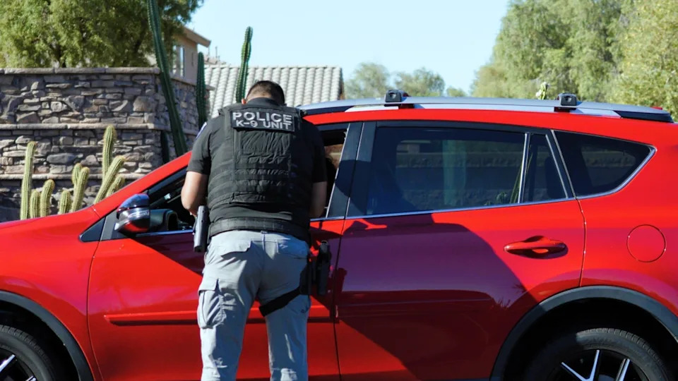 City of Maricopa police officer in the K-9 unit performs a traffic stop on a driver in a residential neighborhood