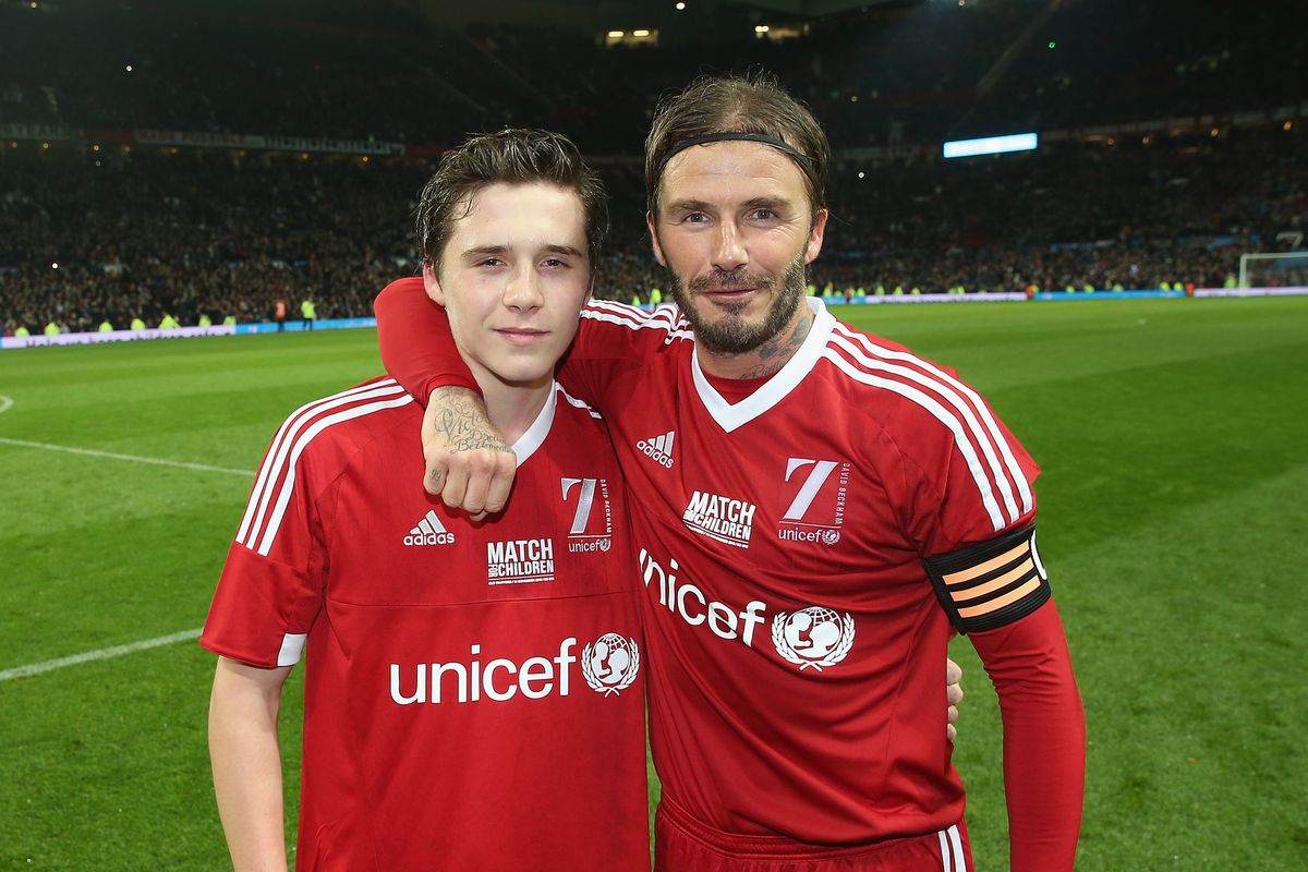 Brooklyn and David Beckham at a charity football match