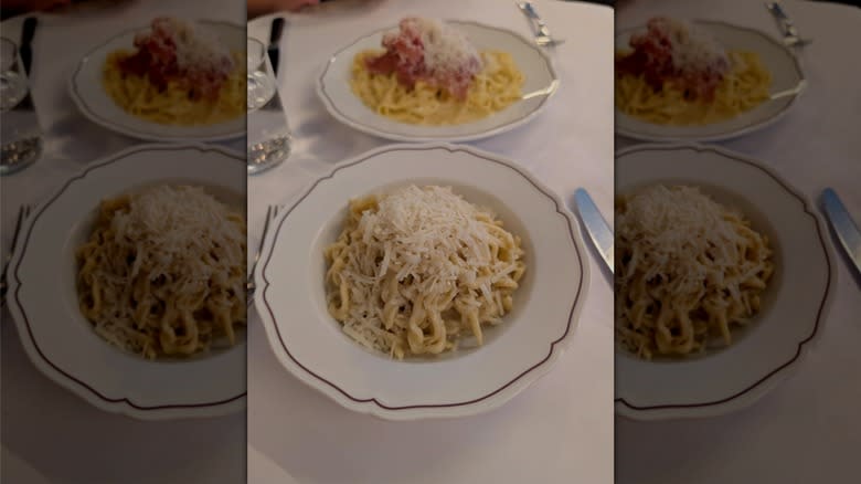 bowl of cacio e pepe topped with grated cheese on dining table at Via Carota Italian restaurant in New York