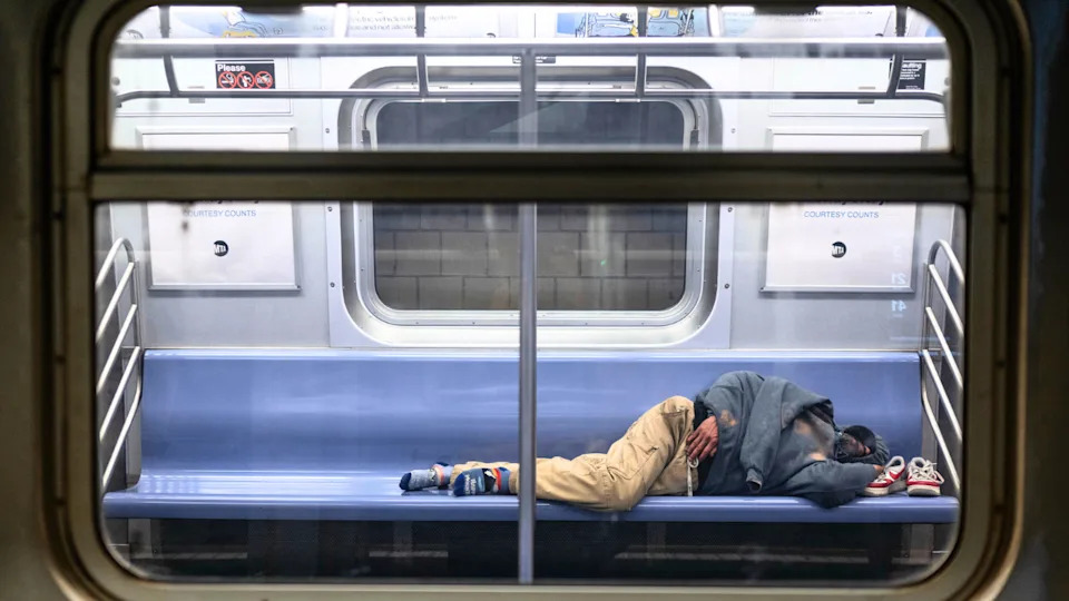A man is seen sleeping on the E train, one of the subway lines most utilized by homeless New Yorkers for shelter on Monday, April 7, 2025.