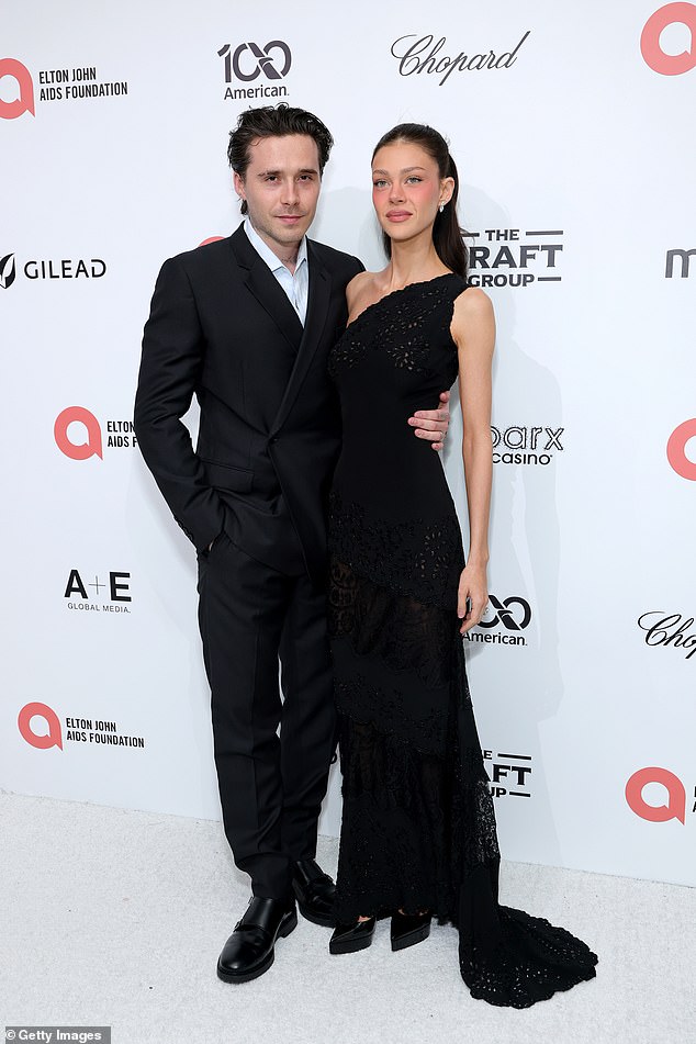 Nicola commanded attention in a form-fitting black gown as she cosied up to her husband Brooklyn at the party