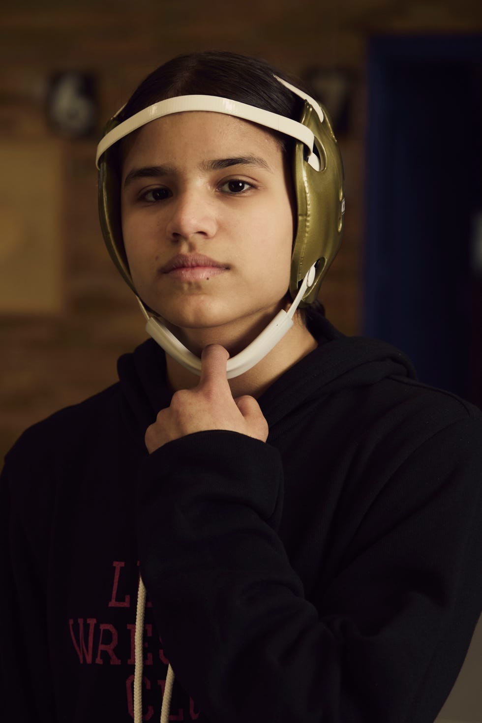 wrestler in a gold headgear expressing thoughtfulness