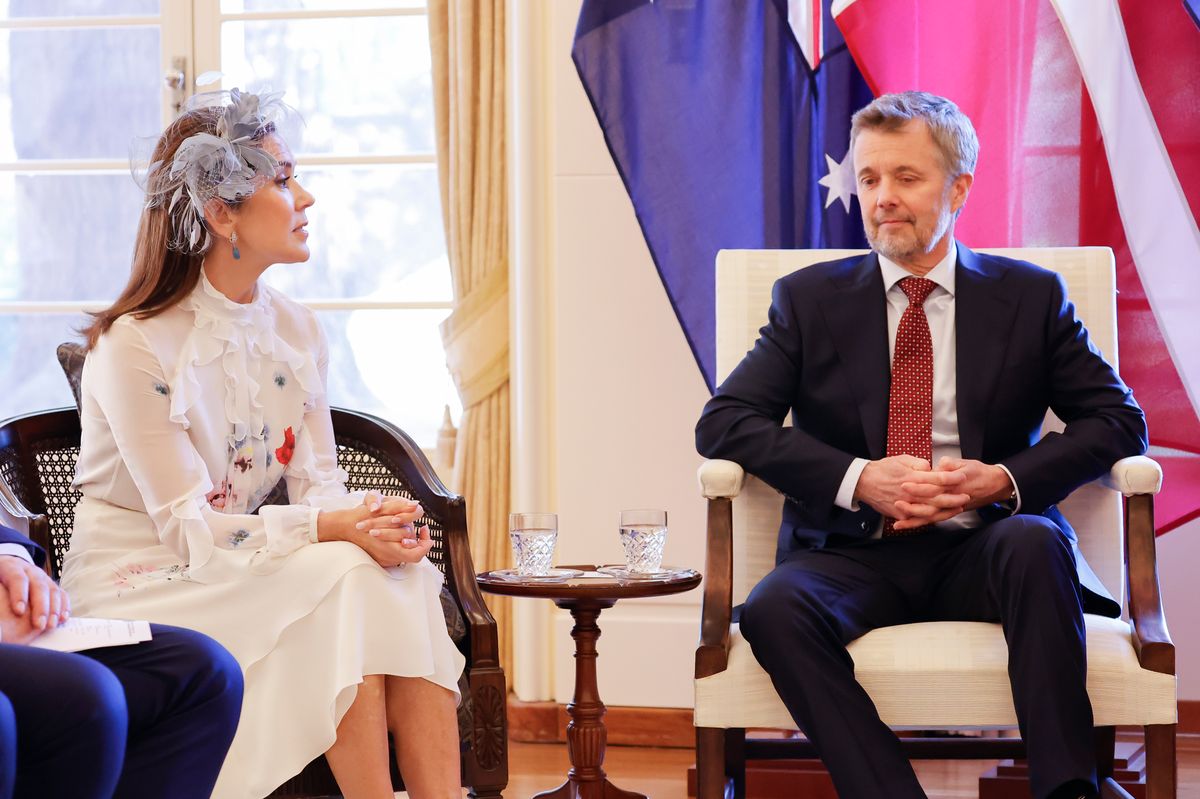 Mary opted for a romantic white ensemble with a delicate floral print, composed of a blouse and matching midi skirt. 