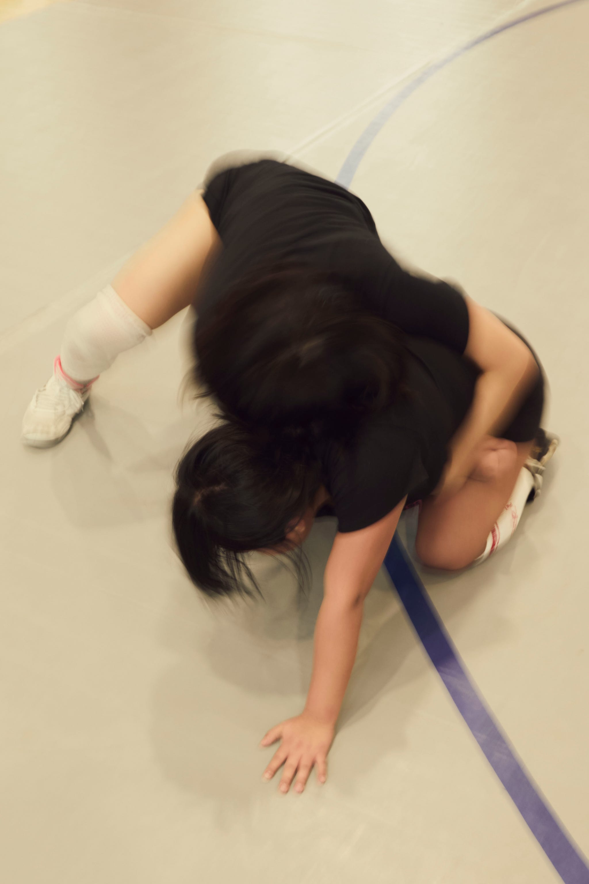 wrestlers in action on a mat during a match