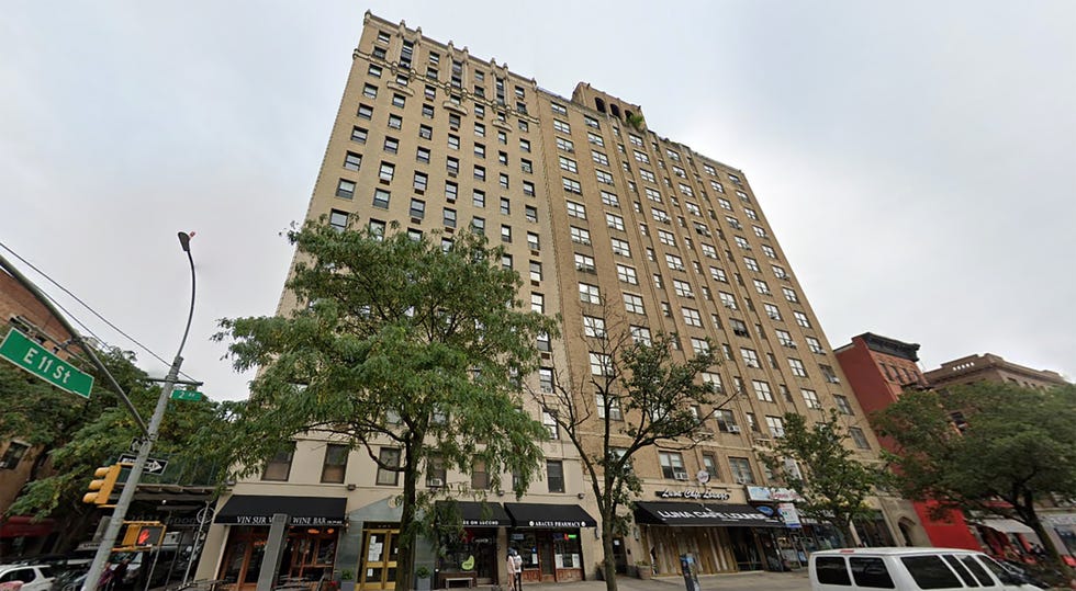 Tall building with commercial spaces at the ground level.