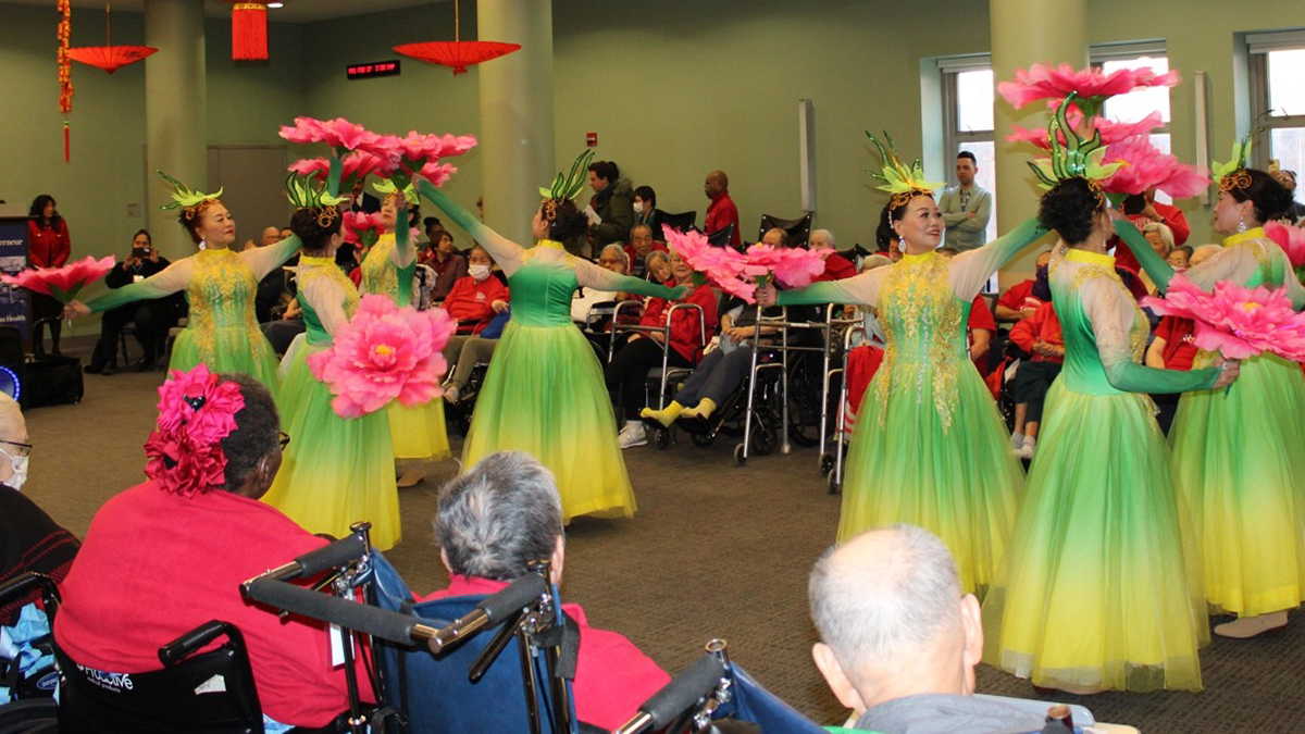 A group of women performing in a room

AI-generated content may be incorrect.