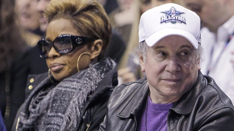 Songwriter Paul Simon, right, and singer Mary J. Blige attend...