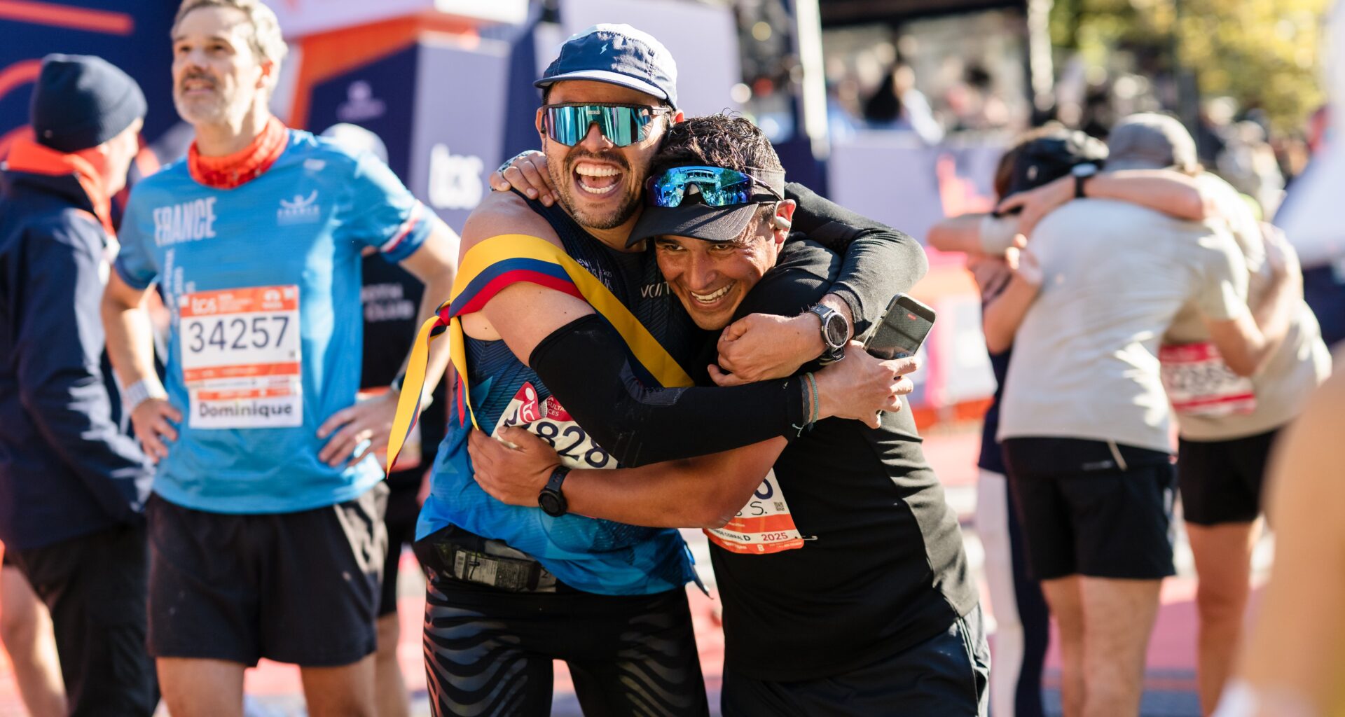 Two men hugging after finishing the 2025 TCS New York City Marathon.