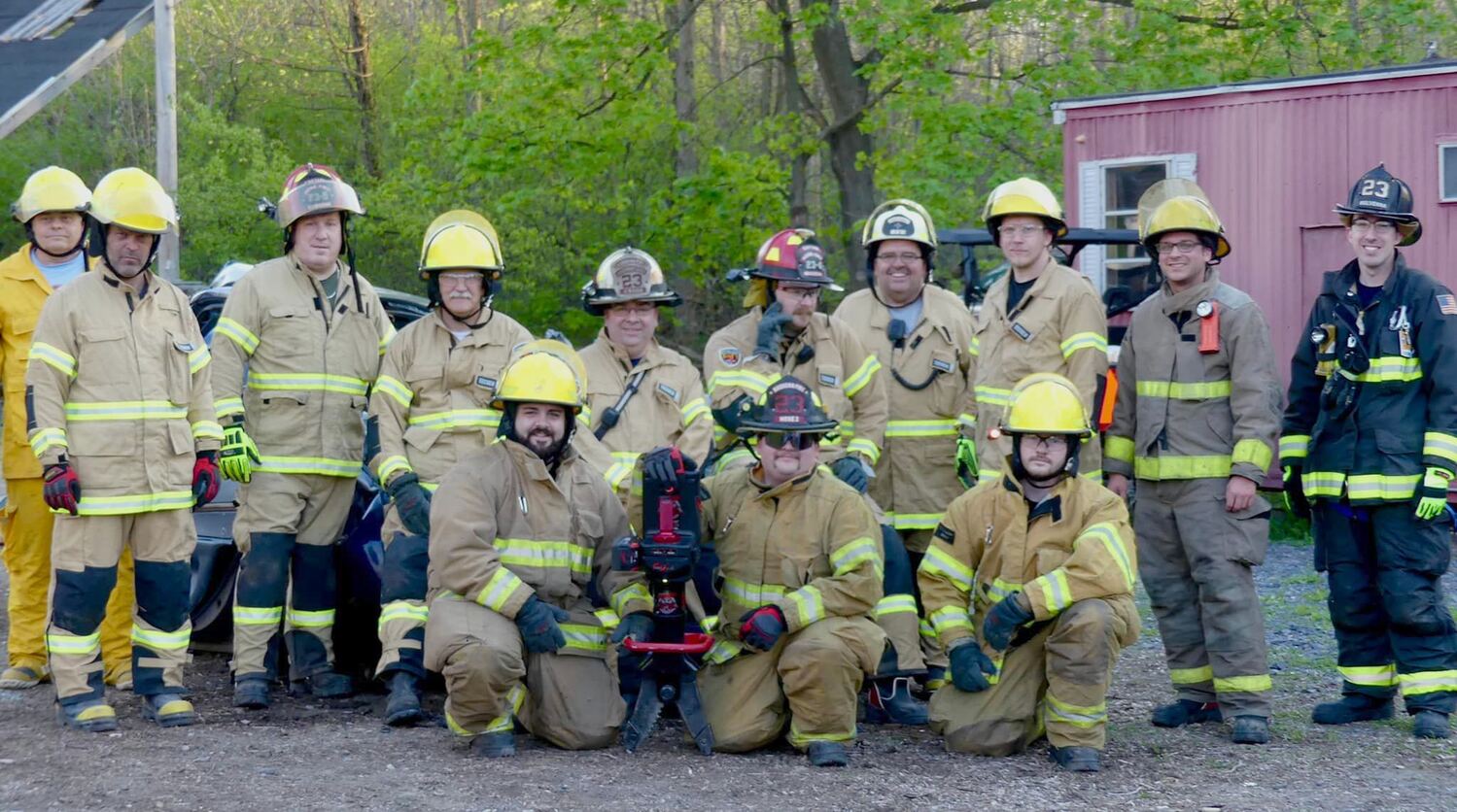 A group of Massena firefighters that had just completed a Vehicle Rescue: Operations Level state certification process with Municipal Fire Instructors Mulvenna and O