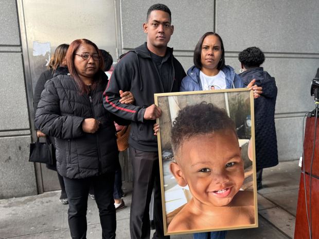 Otoniel Feliz and Zoila Dominici hold a picture of their son, Nicholas Dominici, who lost his life to fentanyl exposure at a Bronx daycare in 2023, outside the Bronx Hall of Justice on Wednesday.