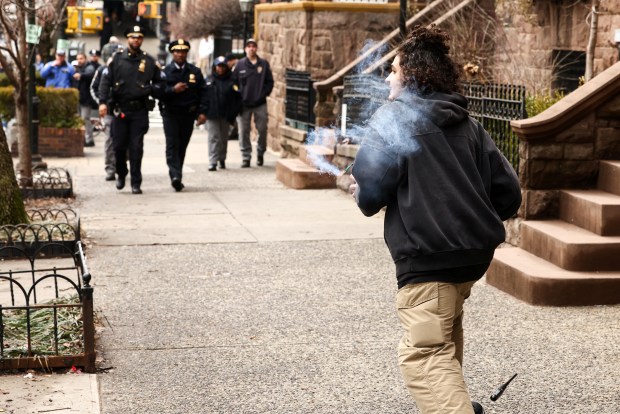 A left-wing activist carries a homemade device during a protest organized by far-right influencer Jake Lang against alleged "Islamification" in front of Gracie Mansion, New York Mayor Zohran Mamdani's official residence, in Manhattan, New York on Saturday, March 7, 2026. (Photo by CHARLY TRIBALLEAU / AFP via Getty Images)