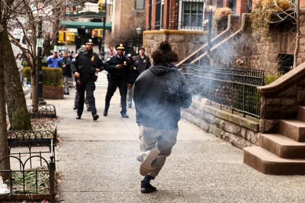 A left-wing activist carries a homemade device during a protest organized by far-right influencer Jake Lang against alleged "Islamification" in front of Gracie Mansion, New York Mayor Zohran Mamdani's official residence, in Manhattan, New York on Saturday, March 7, 2026. (Photo by CHARLY TRIBALLEAU / AFP via Getty Images)