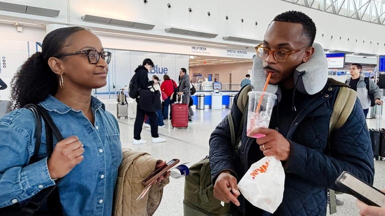 Travelers Kajanna McCenzie, 32, of Philadelphia, with her husband, Josiah...