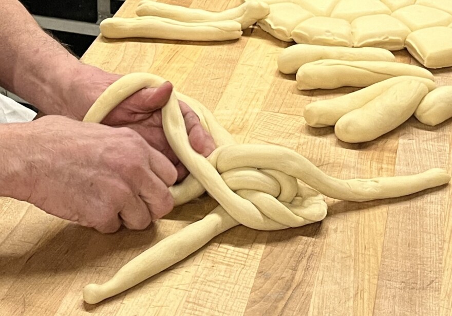 Tom Quinn, head baker at Malek's Bakery in Brighton, preps a load of challah on Jan. 28, 2026, in the back kitchen area of the Monroe Avenue shop. Malek's is the only kosher, dairy-free bakery in the Rochester area.
