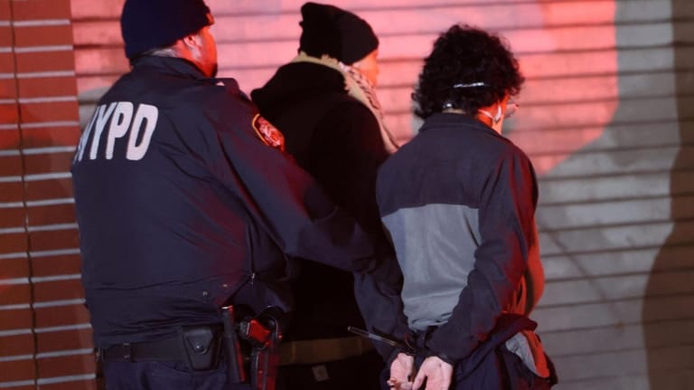 NYPD officers arrest immigration rights activists after a sit-in at...