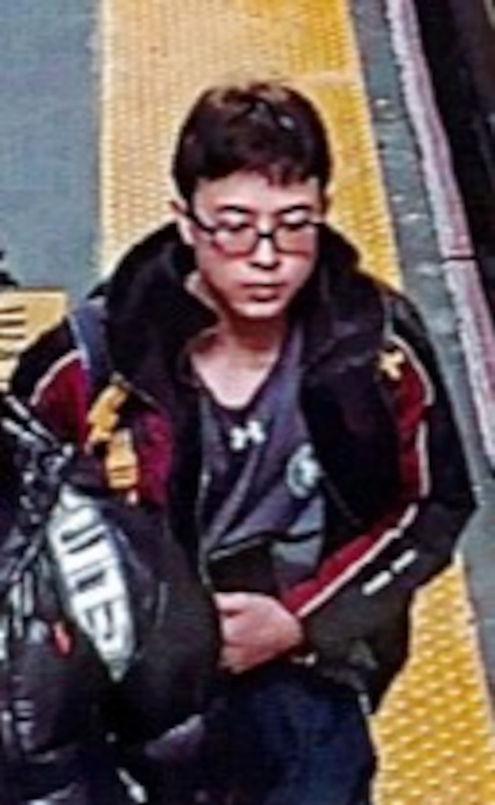 A photo shared by police shows the 15-year-old wearing a backpack and holding a large object...