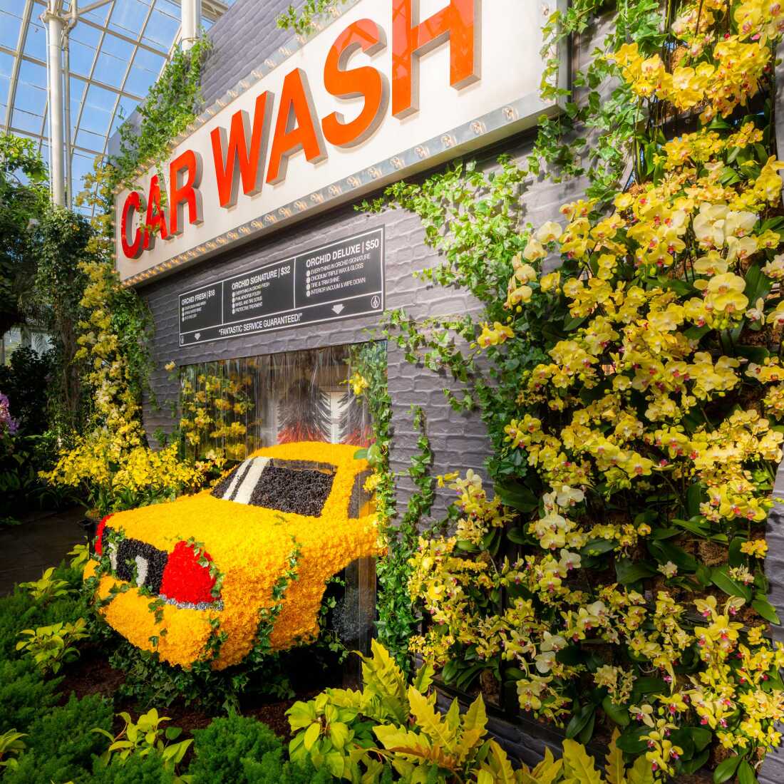 Mr. Flower Fantastic's installations pull from his childhood growing up in New York City — like this car wash. The taxi is made of both real and synthetic carnations.