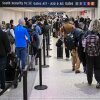 Travelers wait in line at a TSA security checkpoint at George Bush Intercontinental Airport in Houston, Texas, on March 20, 2026.