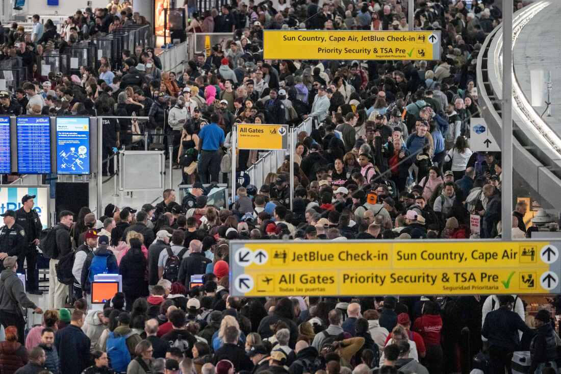 People wait in a TSA line at the John F. Kennedy International Airport, Sunday, March 22, 2026, in New York. (AP Photo/Yuki Iwamura)