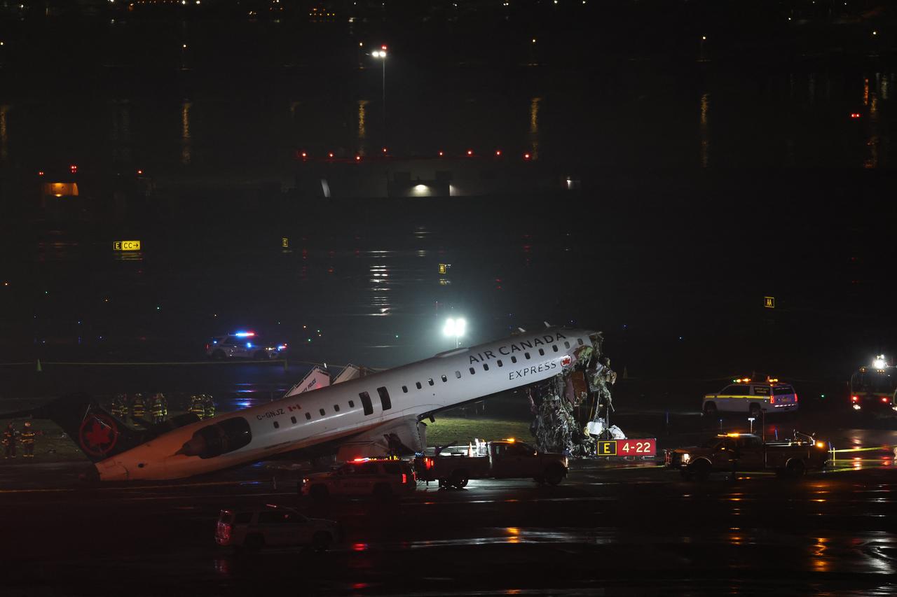 Emergency personnel respond to an Air Canada Express CRJ-900 that is sitting on the runway after colliding with a Port Authority fire truck at LaGuardia Airport in New York, March 23, 2026. (AFP Photo)