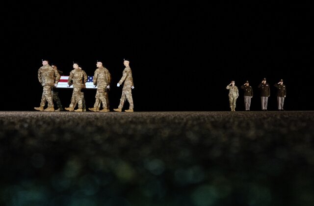 An Army carry team moves the flag-draped transfer case containing the remains of U.S. Army soldier Maj. Sorffly Davius, of Cambria Heights, N.Y., who died in Kuwait, during a casualty return, Monday, March 9, 2026, at Dover Air Force Base, Del. (AP Photo/Julia Demaree Nikhinson)