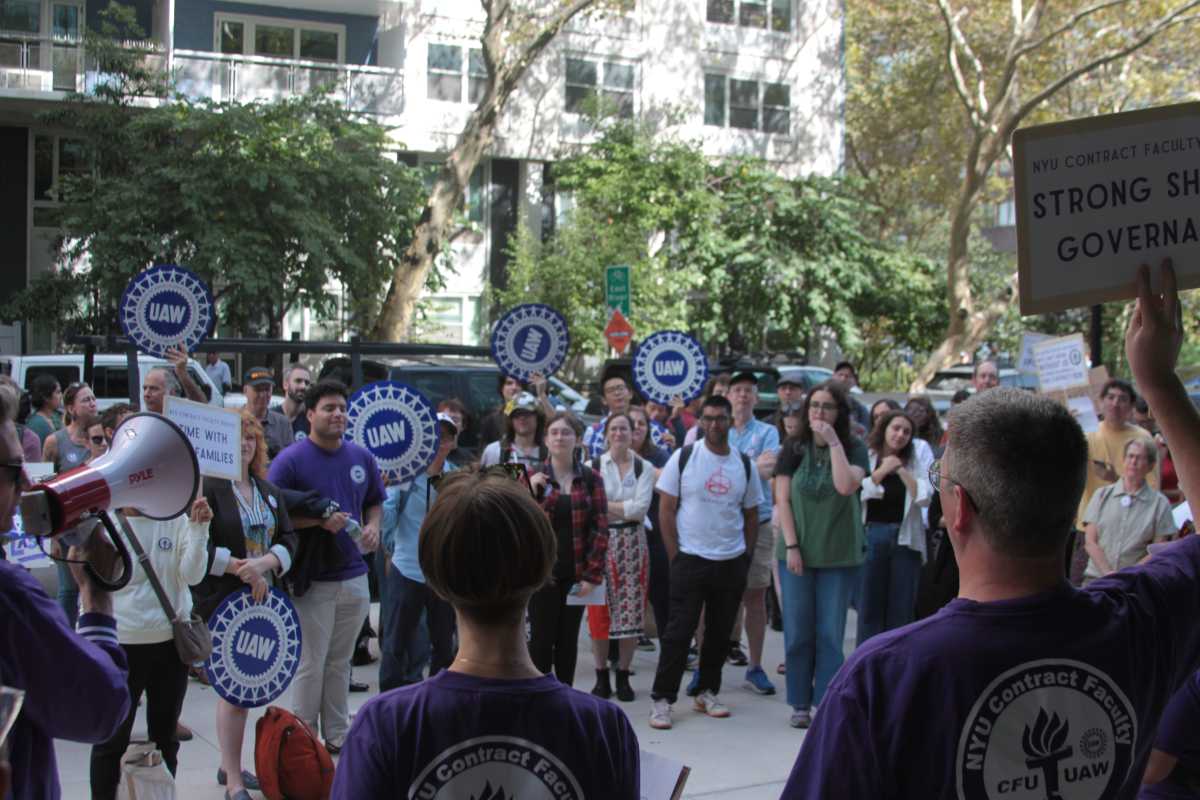 a gathering of people outside holding signs