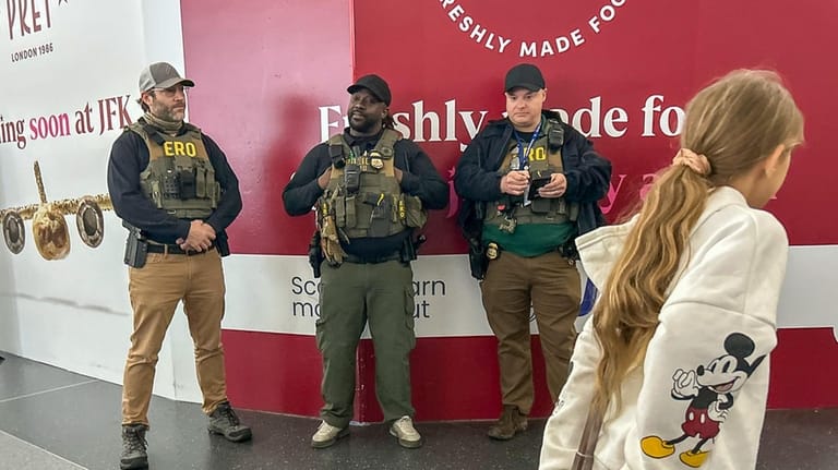 ICE agents are stationed at Kennedy Airport on Monday.