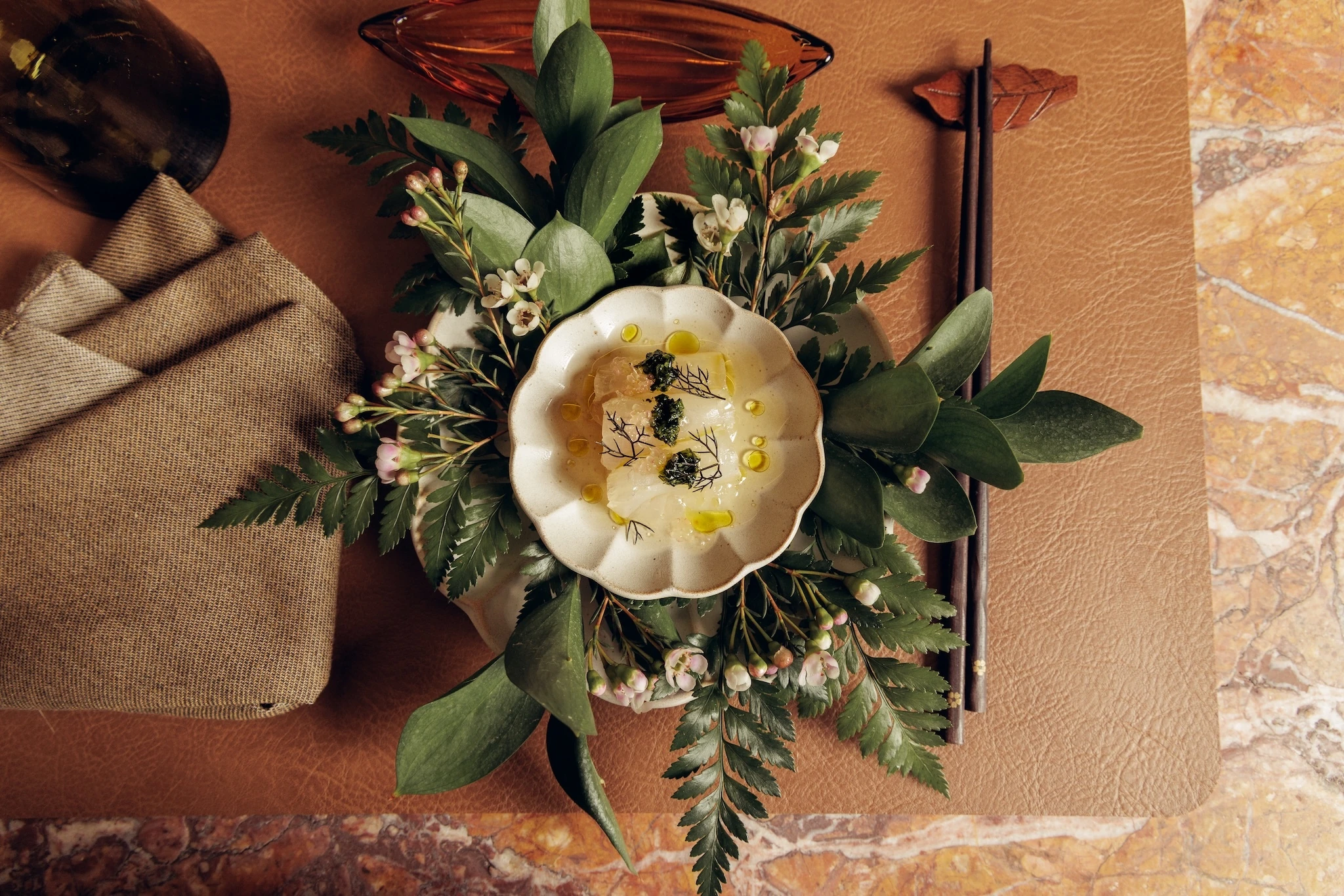 A fish dish on a bed of flowers